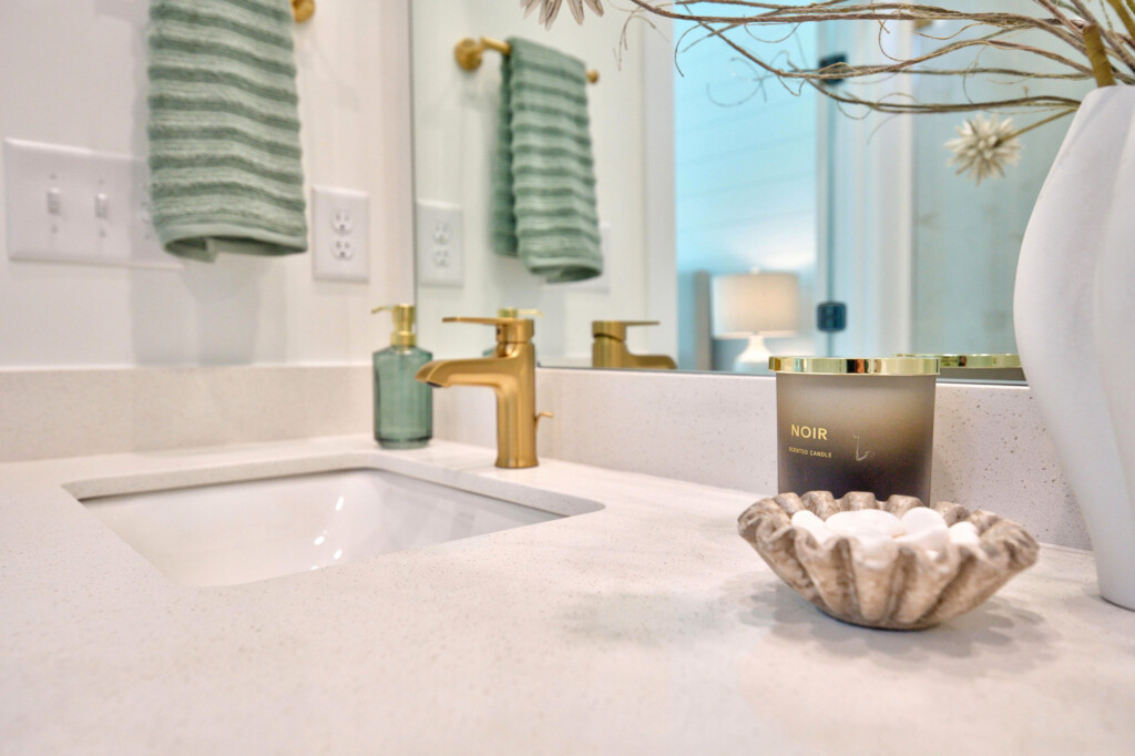 Vanity detail with undermount sink and brass faucet