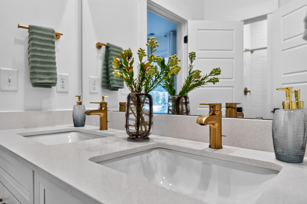 Double vanity with quartz countertop and brass faucets