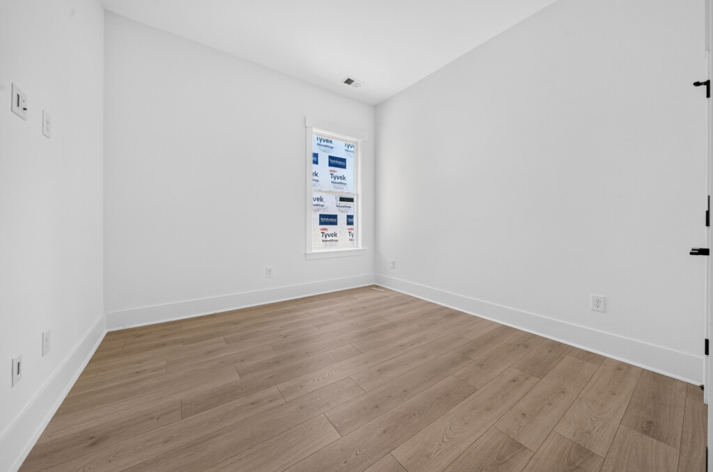 Empty room with light wood-look plank flooring