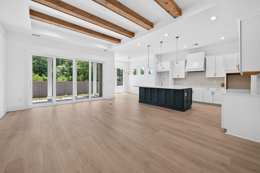 Sanderling Bay great room with wood beams and wood-look plank flooring by J&S Flooring in Georgetown, SC