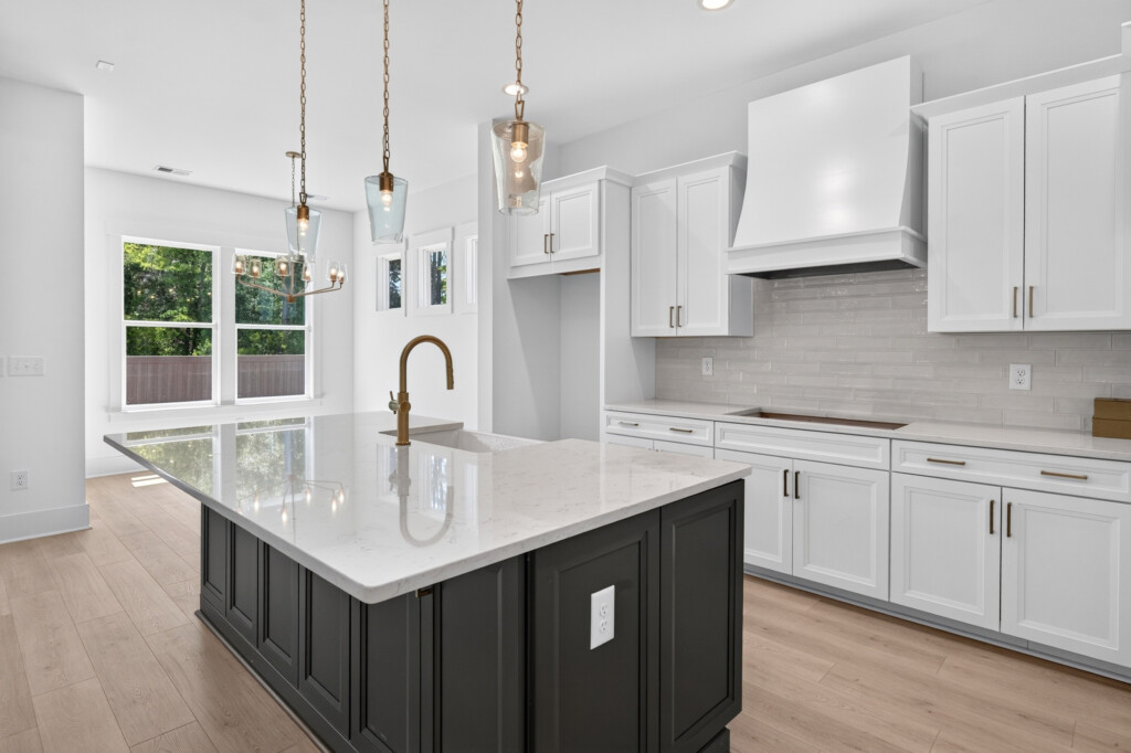 Kitchen island and range hood with light wood-look plank flooring