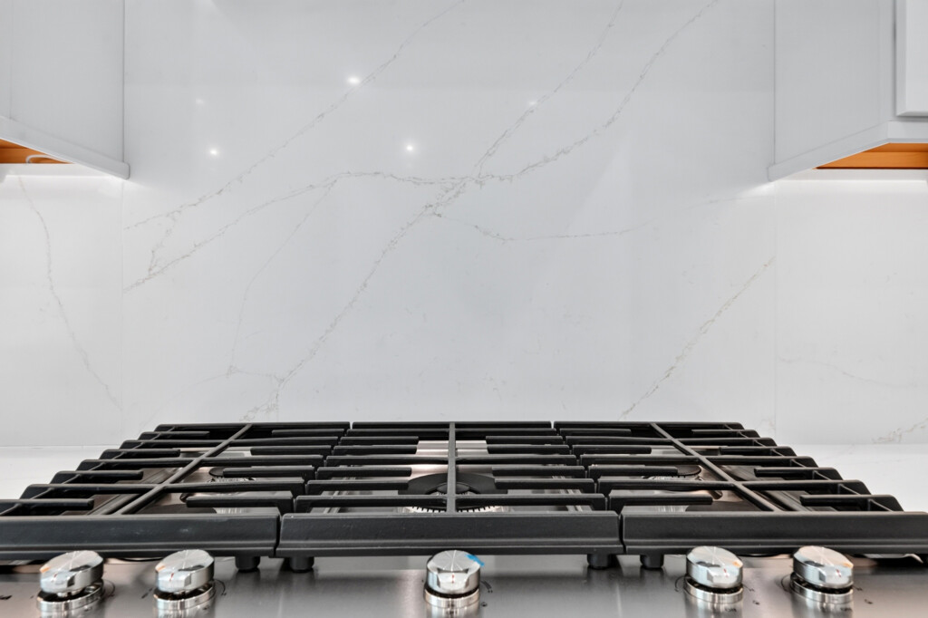 Gas range with quartz slab backsplash