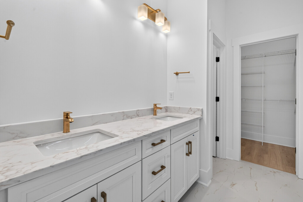 Sanderling Bay bathroom vanity with marble countertop and marble-look floor tile