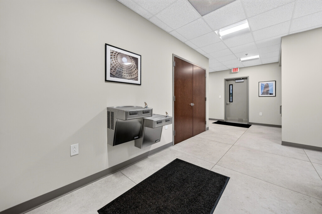 Zilmet USA corridor with water fountain and large-format porcelain floor tile