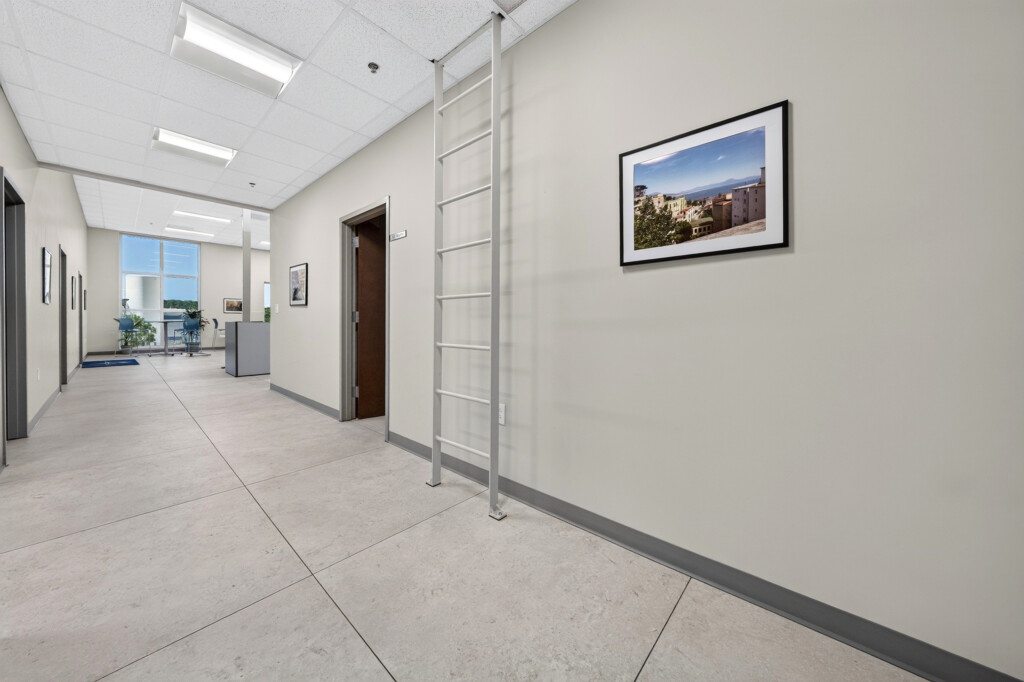 Zilmet USA hallway with framed art and porcelain tile flooring