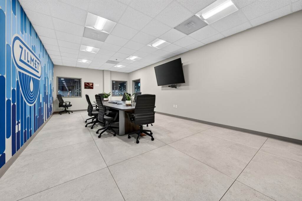 Zilmet USA conference room with branded blue wall mural and porcelain tile floor