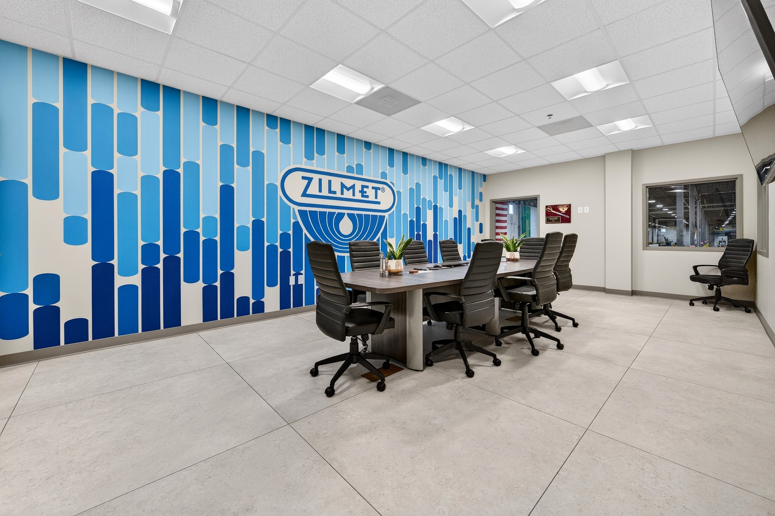Zilmet USA conference room with blue mural and large-format porcelain floor tile
