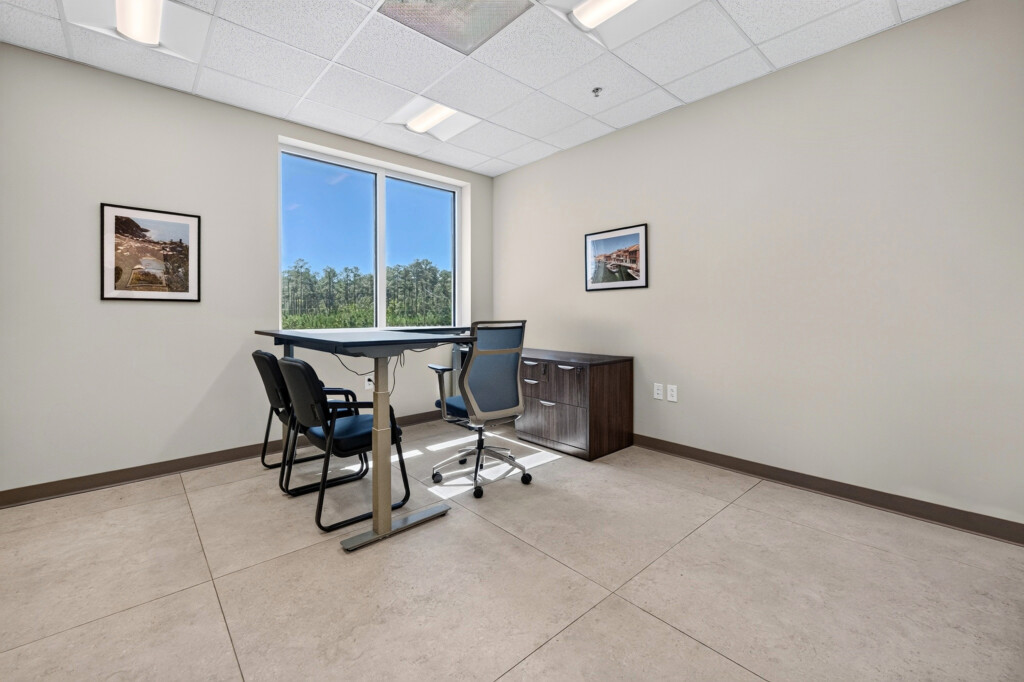 Small office at Zilmet USA with standing desk and porcelain tile flooring